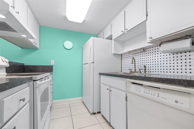 kitchen featuring white appliances, sink, light tile patterned floors, tasteful backsplash, and white cabinetry