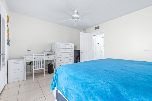 tiled bedroom featuring ceiling fan