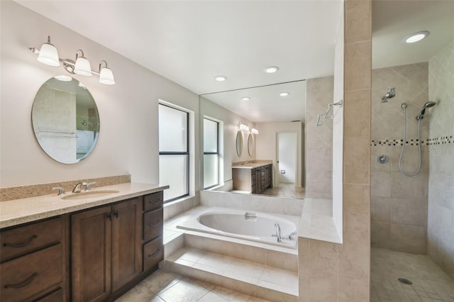 bathroom featuring tile patterned flooring, vanity, and shower with separate bathtub