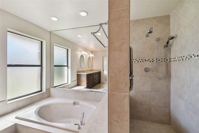 bathroom featuring vanity and independent shower and bath