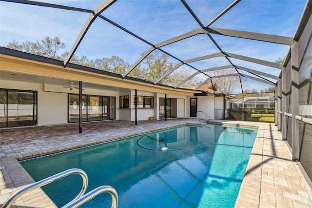 view of pool featuring a patio, a lanai, and ceiling fan