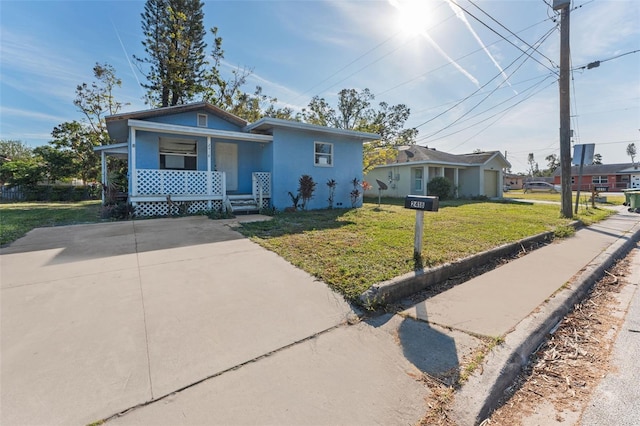 bungalow-style home featuring covered porch and a front yard