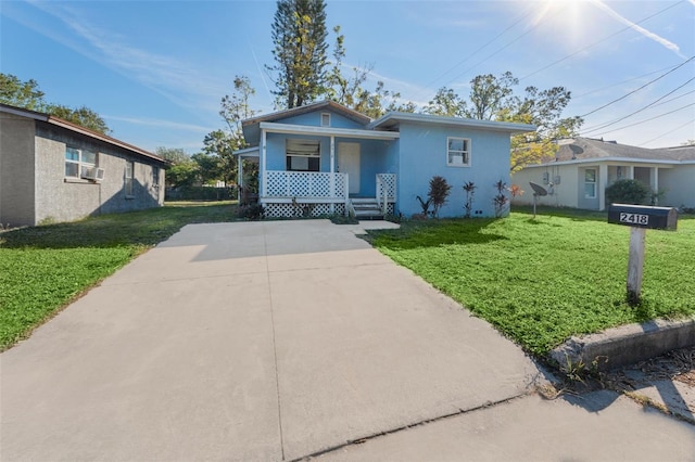 bungalow-style house with covered porch and a front lawn