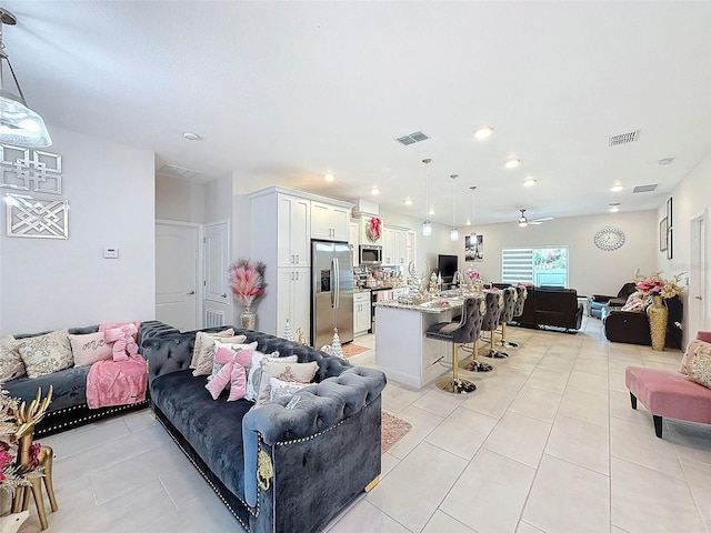 living room with ceiling fan and light tile patterned floors