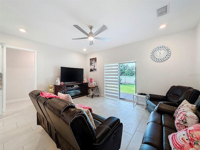 living room with ceiling fan and light tile patterned floors