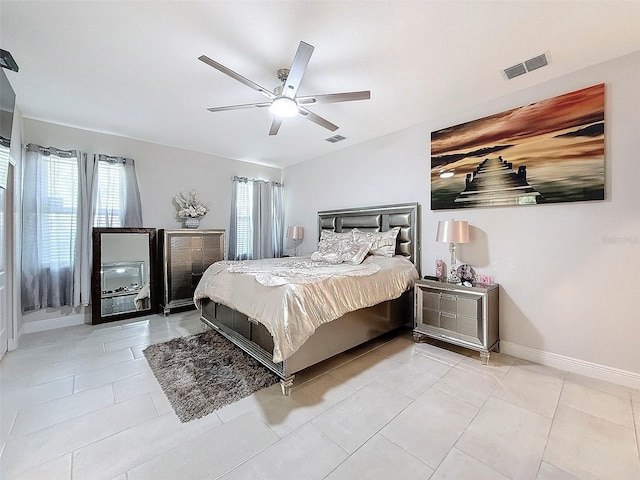 bedroom featuring light tile patterned floors and ceiling fan