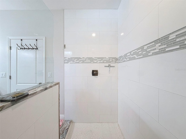 bathroom with a tile shower