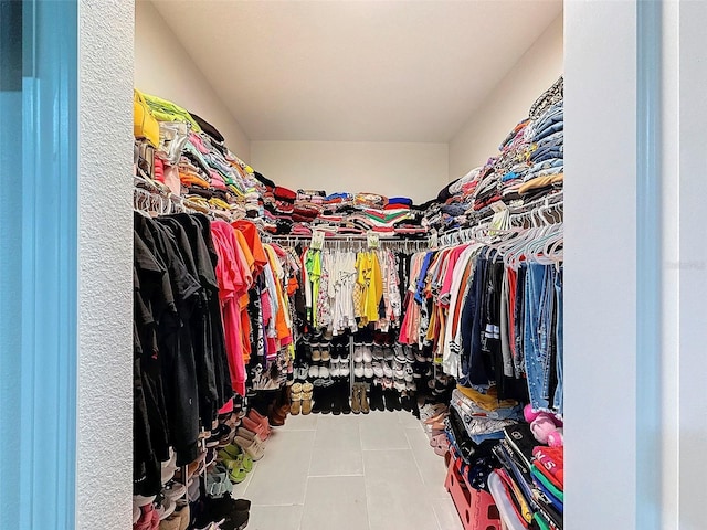 walk in closet with tile patterned flooring