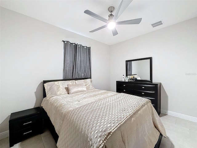 tiled bedroom with ceiling fan