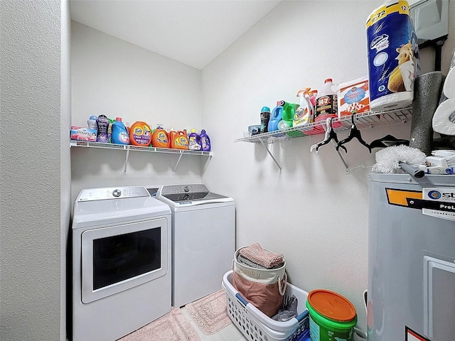 laundry area featuring water heater and independent washer and dryer