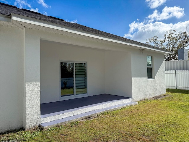 back of property featuring a yard and a patio area