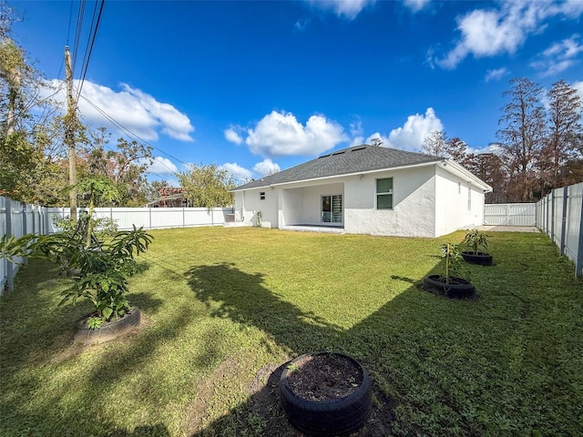 rear view of property featuring a lawn