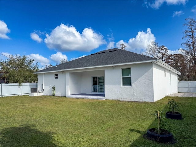 back of property featuring a lawn, central AC unit, and a patio