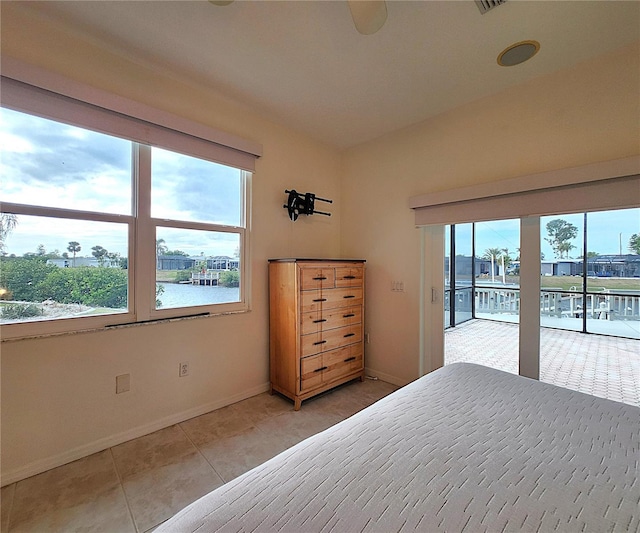 unfurnished bedroom featuring access to outside, baseboards, and light tile patterned floors