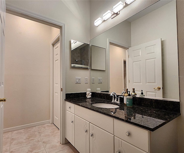 bathroom with baseboards, vanity, and tile patterned floors