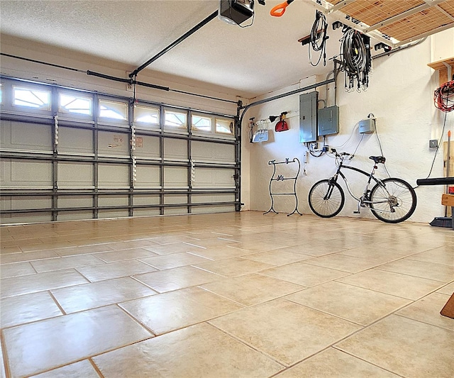 garage with electric panel and a garage door opener