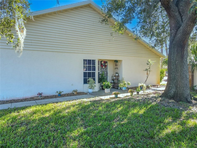 view of home's exterior with a lawn