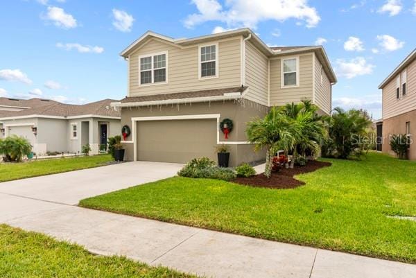 view of front of home with a garage and a front lawn