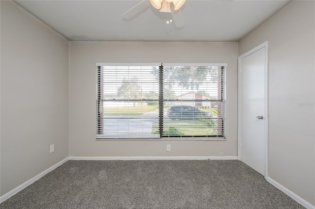 carpeted spare room featuring ceiling fan