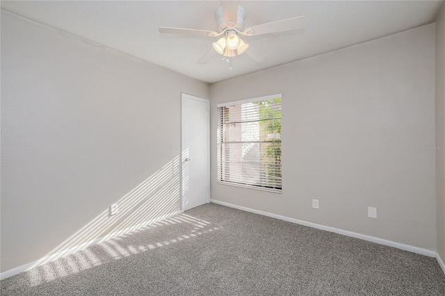 empty room featuring carpet flooring and ceiling fan