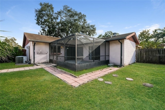 exterior space featuring a lanai, central AC, and a yard