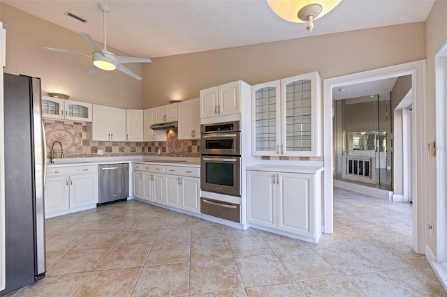 kitchen with white cabinetry, ceiling fan, stainless steel appliances, decorative backsplash, and light tile patterned floors