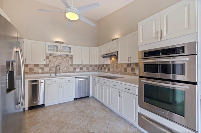 kitchen with white cabinets, appliances with stainless steel finishes, light tile patterned floors, and sink