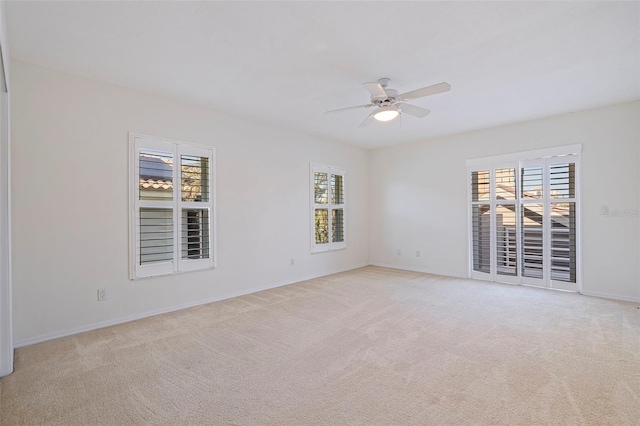 unfurnished room with light colored carpet and a wealth of natural light