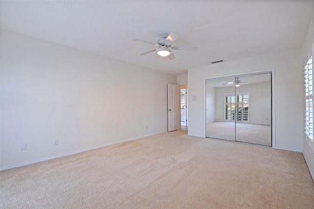 carpeted spare room with ceiling fan