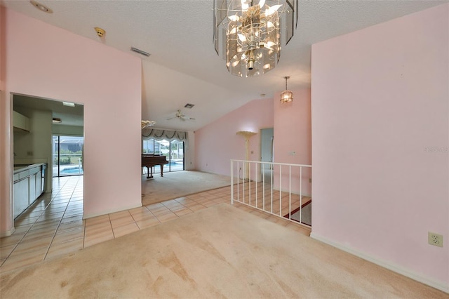 interior space featuring light carpet, a textured ceiling, a chandelier, and vaulted ceiling