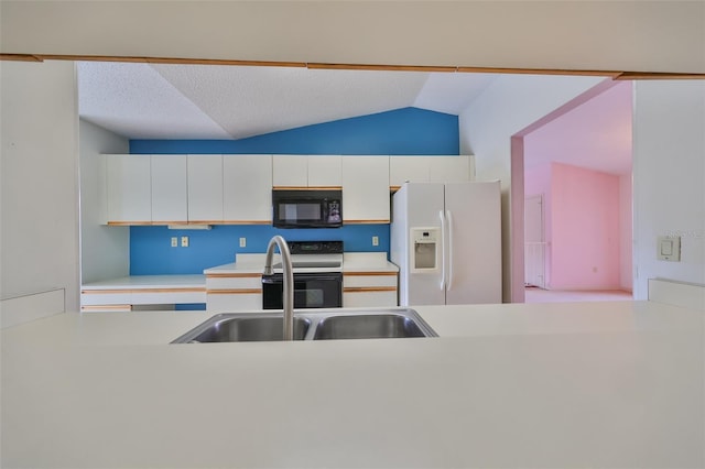 kitchen with white cabinets, lofted ceiling, and black appliances