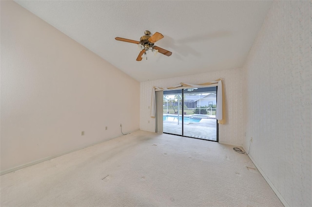 unfurnished room featuring light colored carpet, ceiling fan, and lofted ceiling