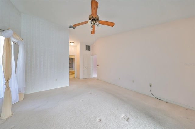 spare room with ceiling fan and light colored carpet