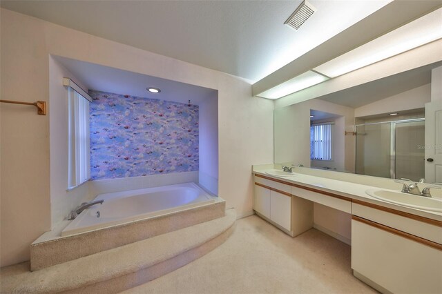 bathroom with vanity, lofted ceiling, and shower with separate bathtub