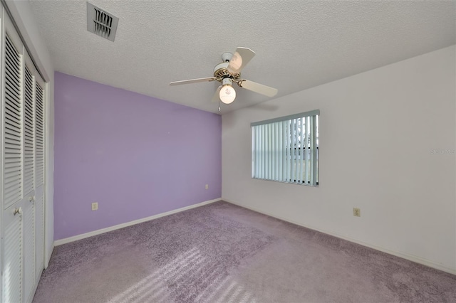 unfurnished bedroom featuring carpet, a closet, and ceiling fan