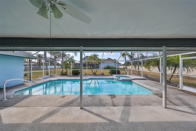 view of swimming pool featuring glass enclosure, ceiling fan, and a patio area