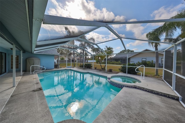 view of pool with an in ground hot tub, a patio, and glass enclosure