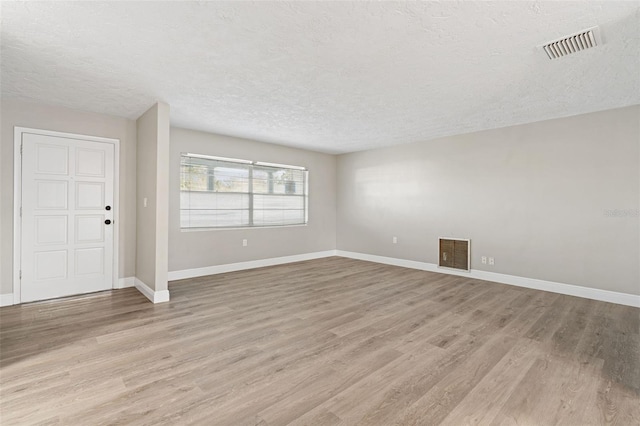 interior space with light hardwood / wood-style floors and a textured ceiling