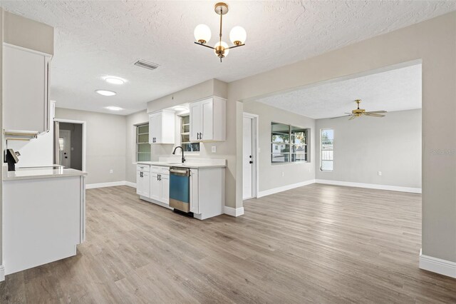 kitchen with white cabinets, ceiling fan with notable chandelier, and light hardwood / wood-style floors