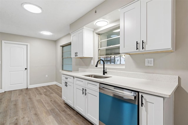 kitchen featuring white cabinets, light wood-type flooring, stainless steel dishwasher, and sink