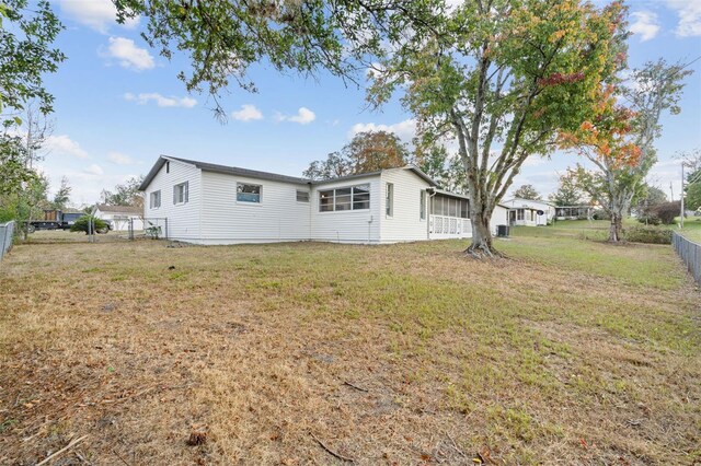 view of side of home featuring a yard