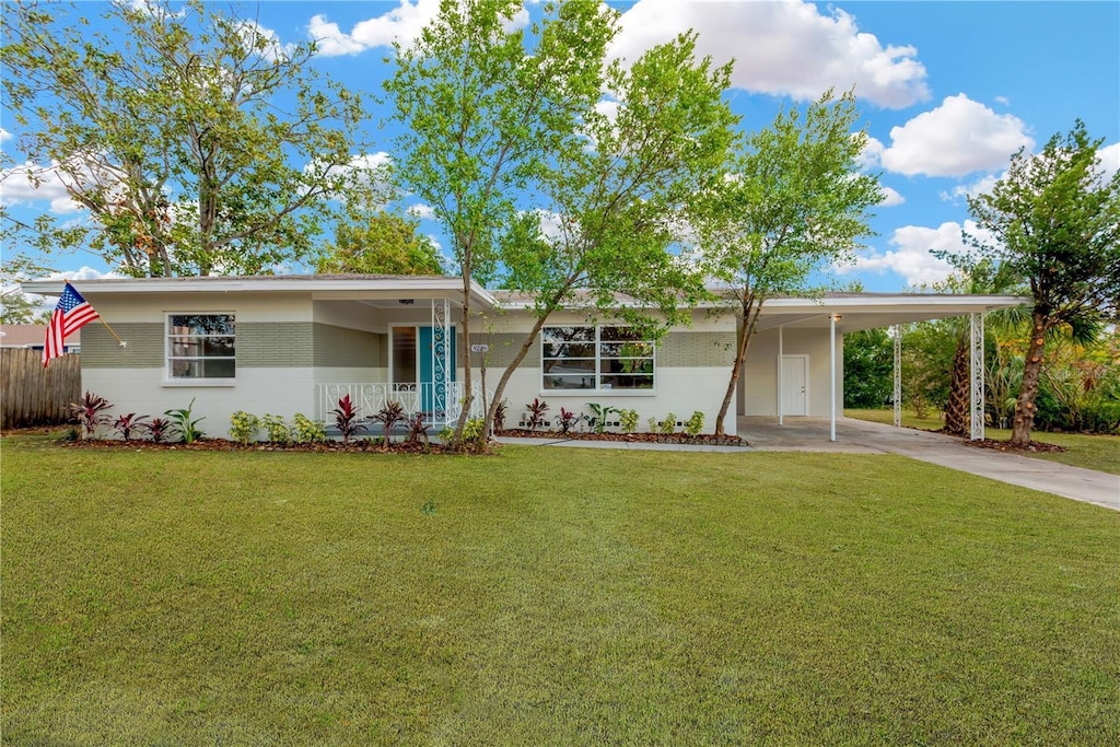 ranch-style house with a front lawn and a carport