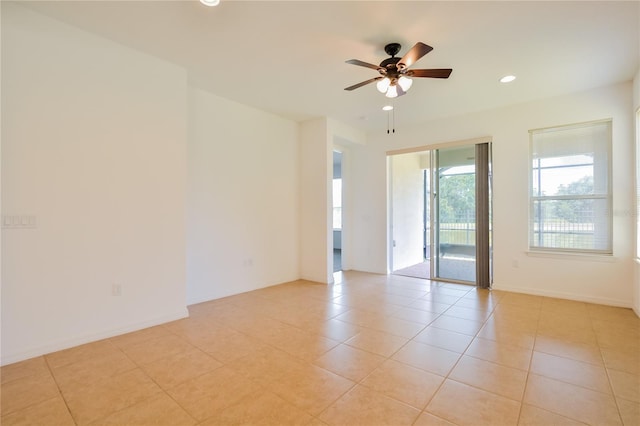 empty room featuring ceiling fan and light tile patterned flooring