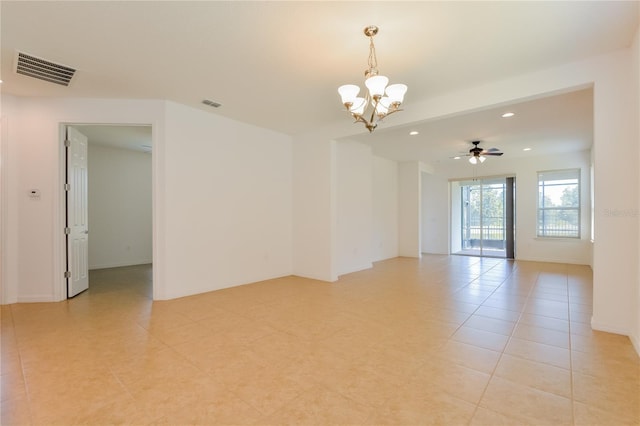 empty room featuring light tile patterned floors and ceiling fan with notable chandelier