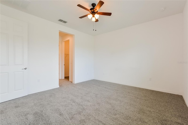 carpeted spare room with ceiling fan