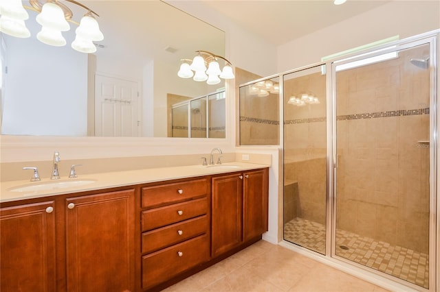 bathroom with tile patterned flooring, vanity, and walk in shower