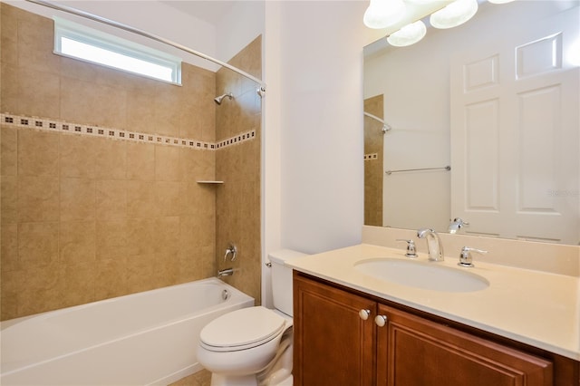 full bathroom featuring vanity, tiled shower / bath combo, and toilet