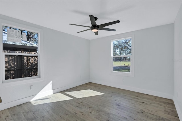 empty room featuring hardwood / wood-style flooring and ceiling fan