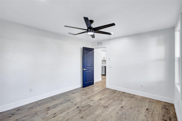 spare room featuring ceiling fan and light wood-type flooring