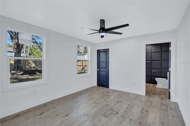 unfurnished bedroom with ceiling fan, light hardwood / wood-style floors, and multiple windows